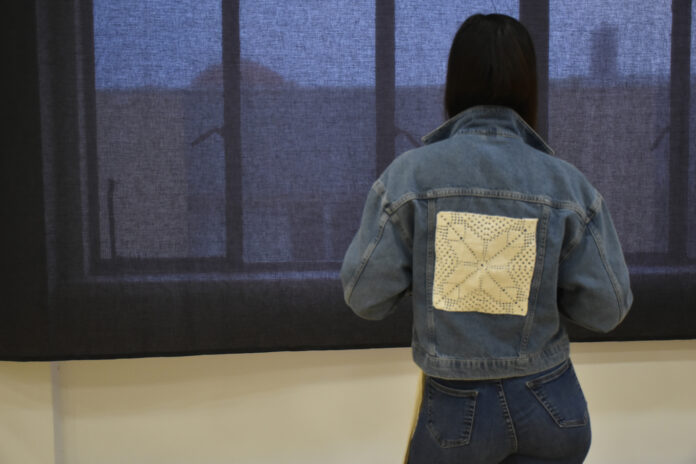 woman posing with jean jacket with crochet embroider